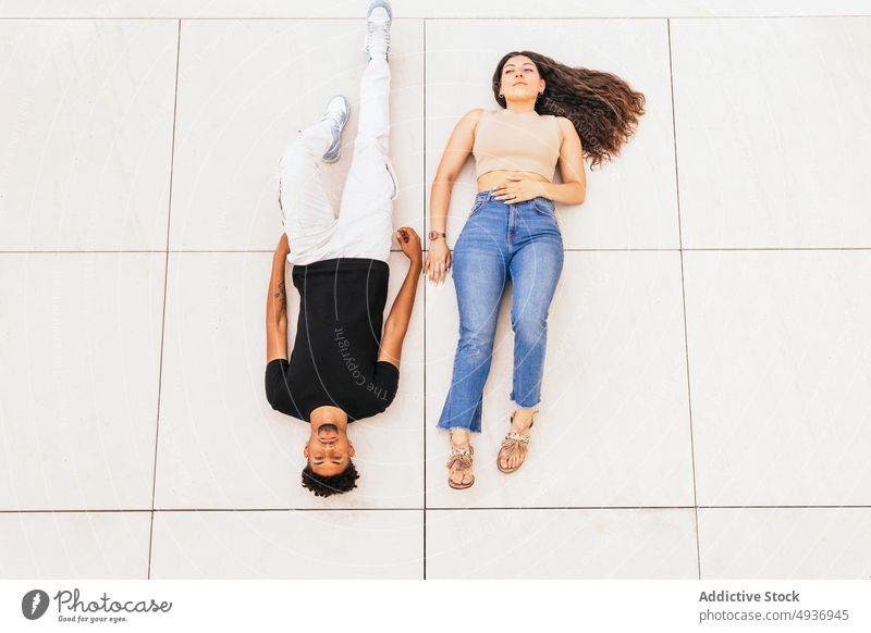 High Angle View Of Couple Lying On Floor Back Flooring Full Length Portrait Relaxing Together Lifestyle Love Casual Clothes Leisure Bonding Dating Friend