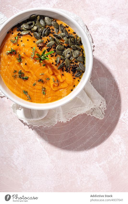 Bowl with delicious pumpkin cream soup served on table puree seed bowl food healthy food dish meal tasty seasoning nutrition rustic gourmet appetizing sunlight