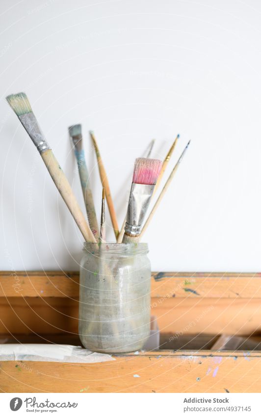 Jar with brushes on easel jar paintbrush paper workshop art blank creative craft hobby dirty set inspiration glass supply sheet workplace canvas wooden