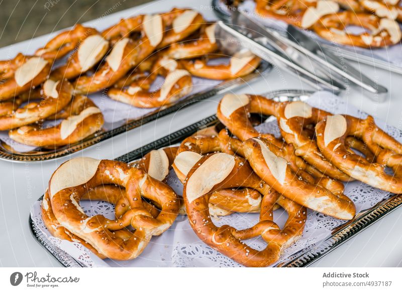 Appetizing pretzels served on trays on table pastry baked delicious bread snack event cater tradition yummy bakery park banquet appetizing delectable treat