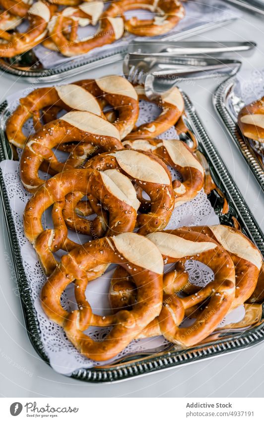 Appetizing pretzels served on trays on table pastry baked delicious bread snack event cater tradition yummy bakery park banquet appetizing delectable treat