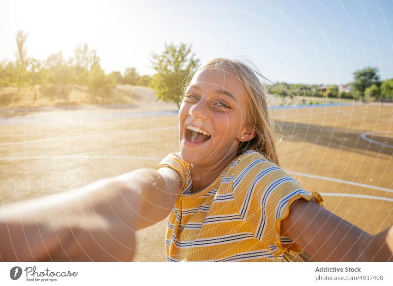 Smiling girl taking selfie on street teenage self portrait photography city social media happy kid cheerful positive playground optimist glad smile charming