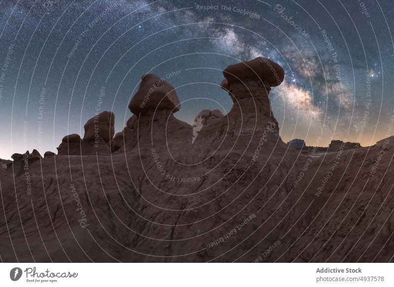Stone formation against starry sky stone desert hole sand dry ground landscape rock arid geology terrain night dark boulder rough drought picturesque unusual