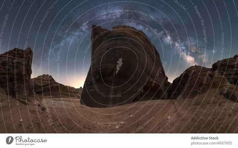 Stone formation against starry sky stone desert hole sand dry ground landscape rock arid geology terrain night dark boulder rough drought picturesque unusual