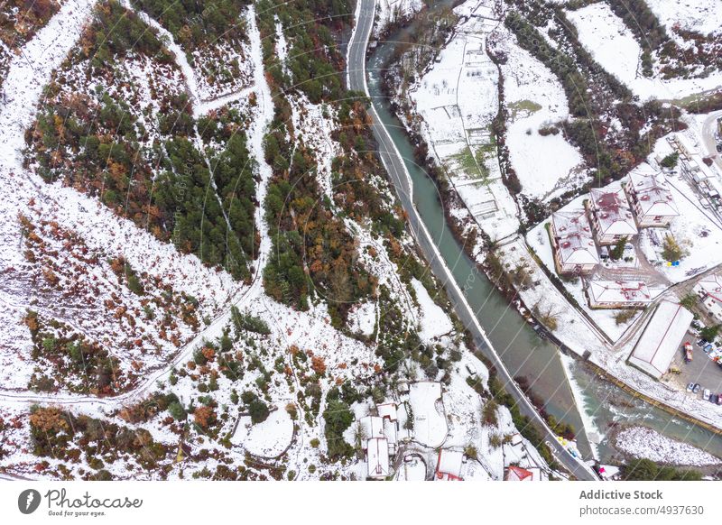 Snowy town in mountains on gloomy day in Spain scenic untouched fanlo village season coniferous wild from above valley scenery remote neighborhood terrain