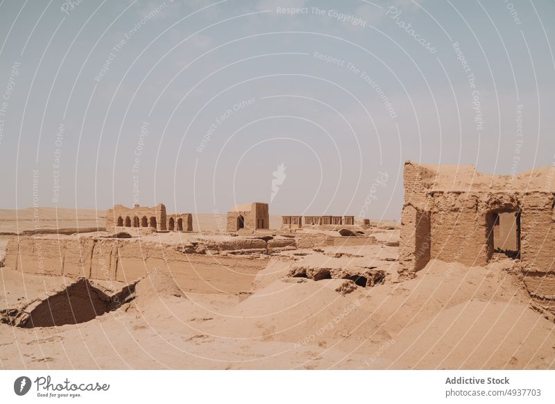 Old caravanserai in desert on sunny day ruin heritage historic travel culture religion ancient sand landmark architecture old archaeology tourism aged