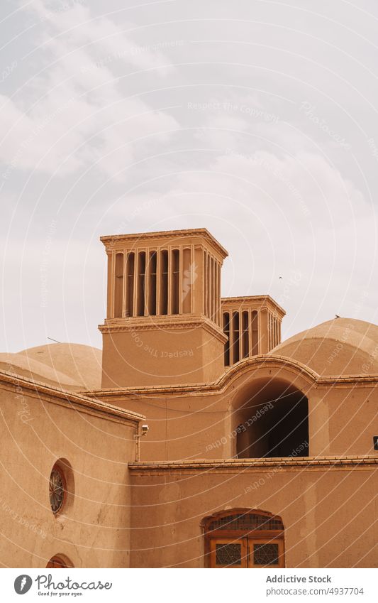 Oriental style clay buildings under cloudy sky in old town facade desert architecture residential district historic simple heritage culture aged tradition