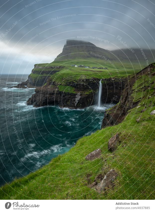 Stormy sea and cliffs at sunrise wave storm rock energy splash cloudy sky faroe islands morning weather water coast ocean shore dawn seascape rough dramatic