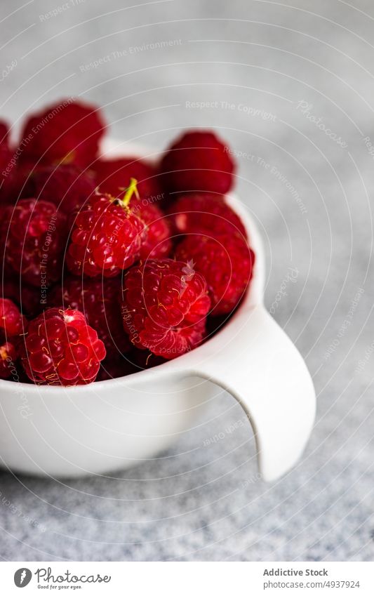 Ripe raspberries in the bowl assortment background berry close up concrete food fresh fruit healthy organic raspberry red ripe seasonal summer table variety