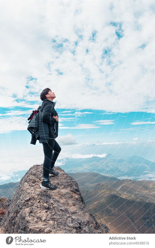 Traveling woman standing in mountains freedom carefree traveler hiker top viewpoint female adventure journey nature serene enjoy quiet backpack highland explore