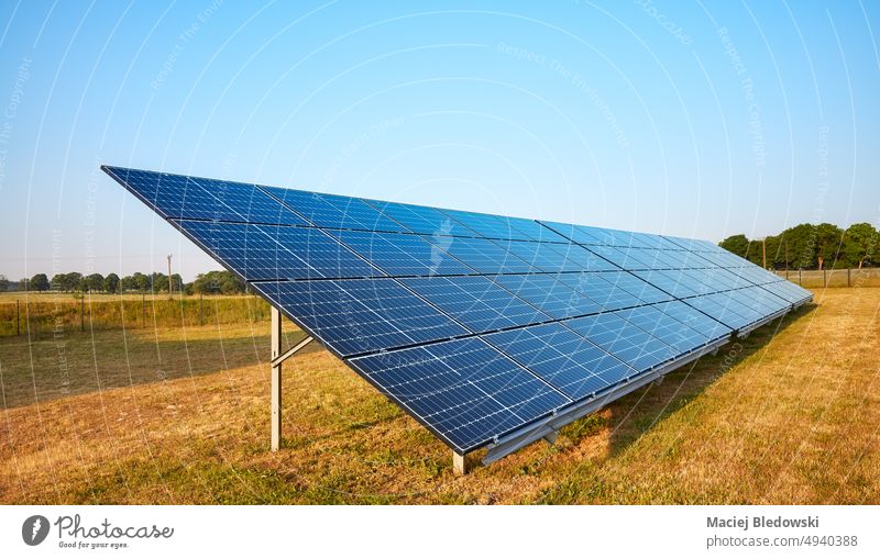 Picture of solar panel modules on a field, selective focus. sun eco nature technology RES blue energy photovoltaic alternative electricity power renewable sky