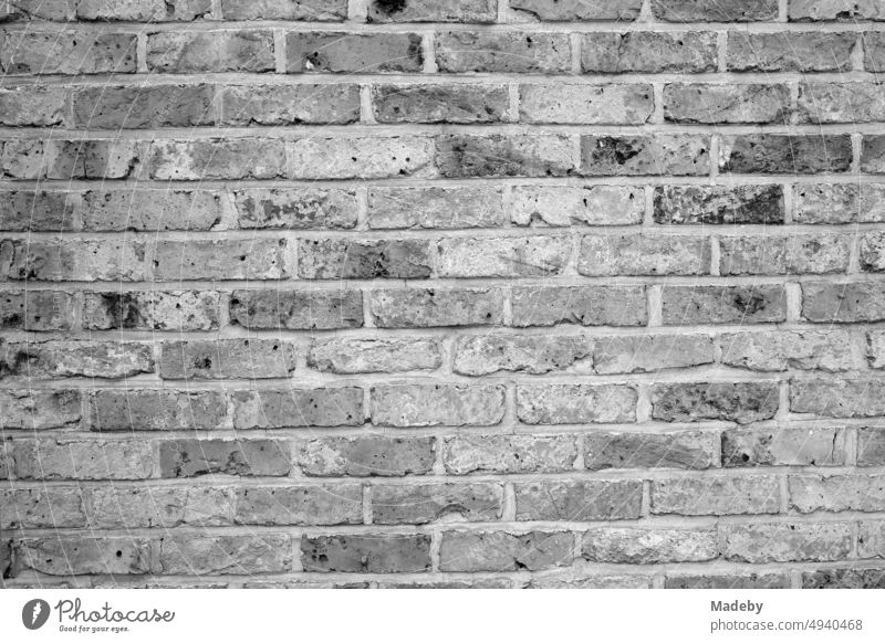 Old brick and natural stone masonry of a residential house in Knokke-Heist on the North Sea near Bruges in West Flanders in Belgium, photographed in classic black and white