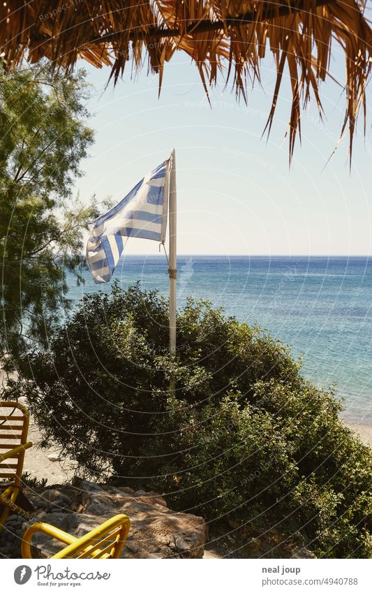 Greek flag, green bush, azure sea and the palm roof of a beach café vacation Summer vacation Ocean Blue sky Vacation & Travel Exterior shot coast Tourism