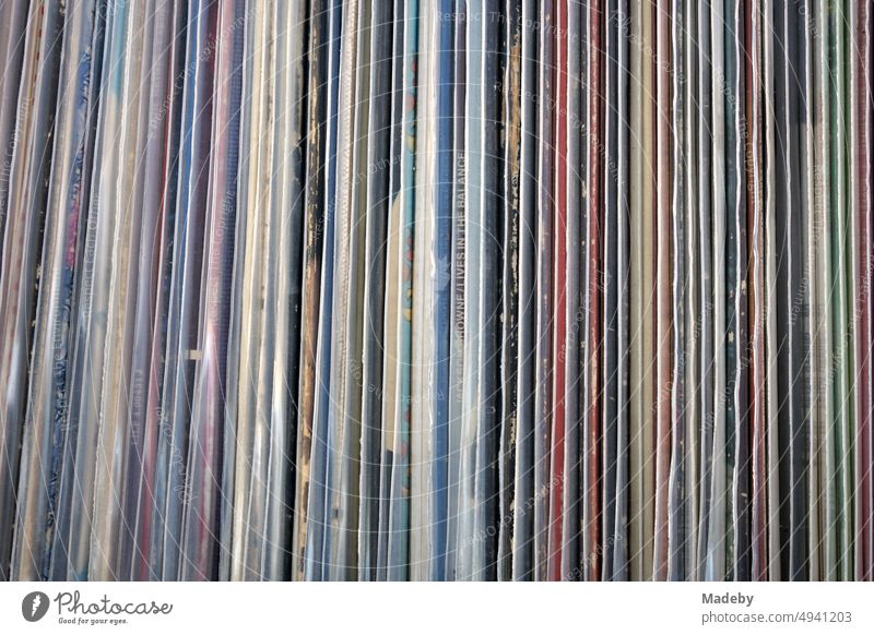 Old colorful records and long-playing records in transparent protective sleeves in front of a record store in the Bornheim district of Frankfurt am Main in the German state of Hesse