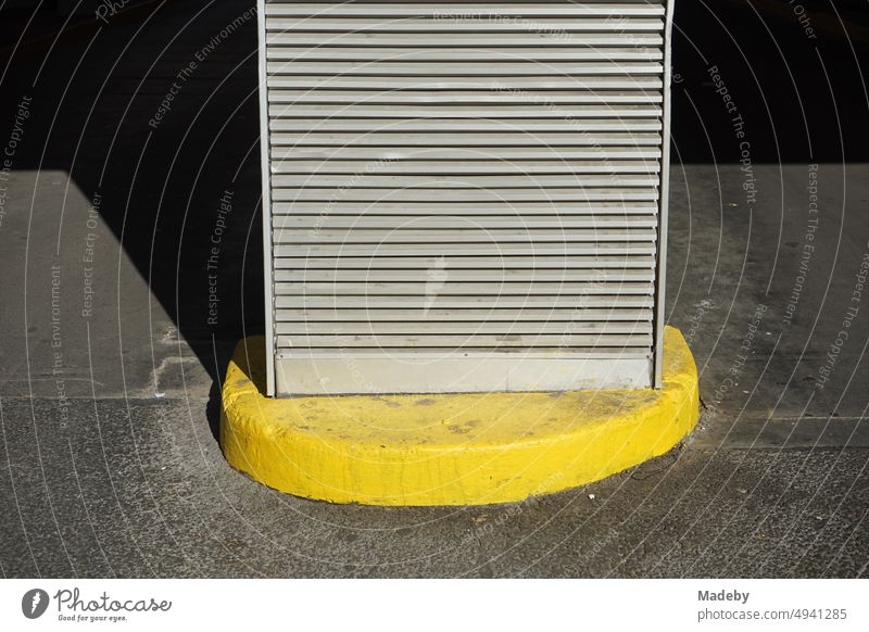 Ventilation grille on a bright yellow base in the sunshine at the entrance of a parking garage in downtown Frankfurt am Main in Hesse, Germany Parking lot