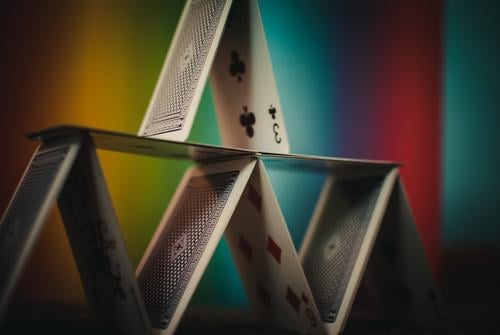 Nightlife // The house of cards with 9 cards stands in front of a colorful background. Chart house Joy Playing Leisure and hobbies Multicoloured Colour photo