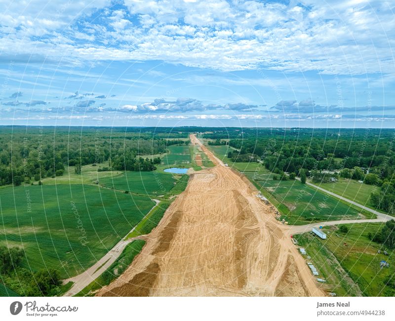 New Highway being built in rural wisconsin grass surface street land background roadway route drone scenic architecture environment green color remote location