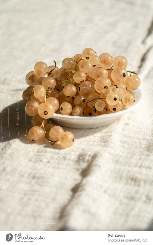 Close-up of fresh white currants in small bowl, white background fruit berry produce food tasty farmer picking Ribes rubrum whitecurrant preserves jam crop
