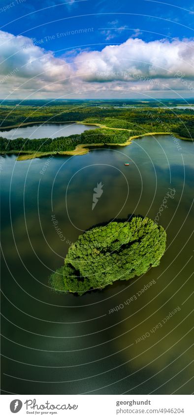 Wooded island in a lake landscape. Aerial view. Forest Lake Mecklenburg vorpommenr Brandenburg Uckermark Island werder drone aerial photograph Rafts wide Sky