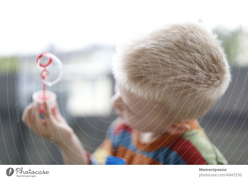 blond boy with soap bubble Soap bubble variegated Dream dream Child Children's game Playing Discover Infancy Childhood memory Joy Leisure and hobbies Happy