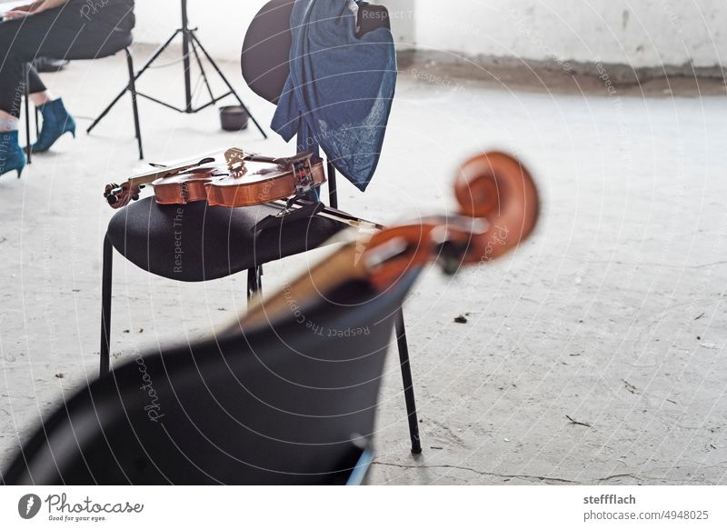 Break during rehearsal of old music in an abandoned industrial loft Violin fiddles Chair chairs Music classical music Early music Industrial loft Loft notes