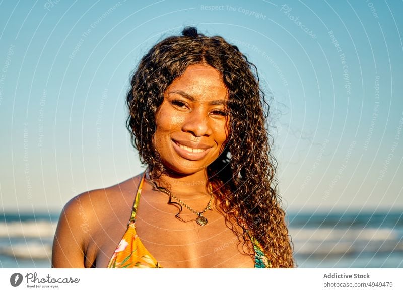 Happy black woman near sea beach smile tourist weekend happy bikini summer vacation female wave resort african american ethnic holiday optimist glad tourism