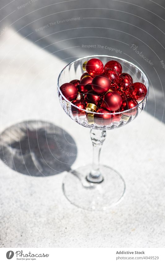 Holiday card concept with red baubles and glass ball decoration champagne christmas deep shadow festive holiday sparkling wine xmas celebrate design color