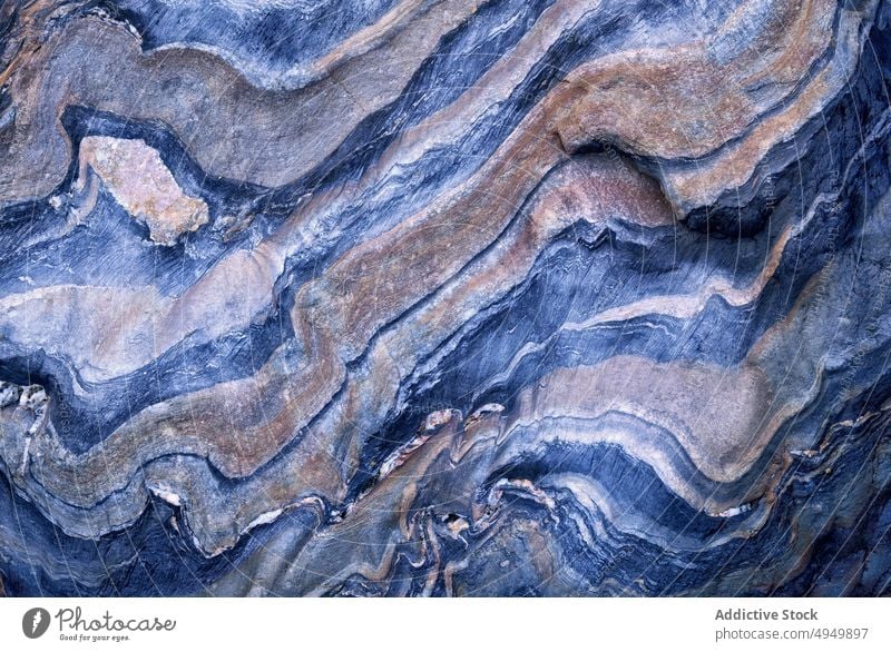 Surface of blue metamorphic rock abstract ornament smooth wavy background texture natural surface material mineral fragment uneven effect curve detail part