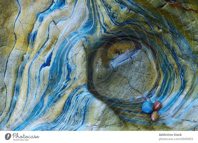 Pebbles inside hole in rock pebble smooth colorful mineral natural surface bunch abstract element detail circle rough material shape round small stone formation