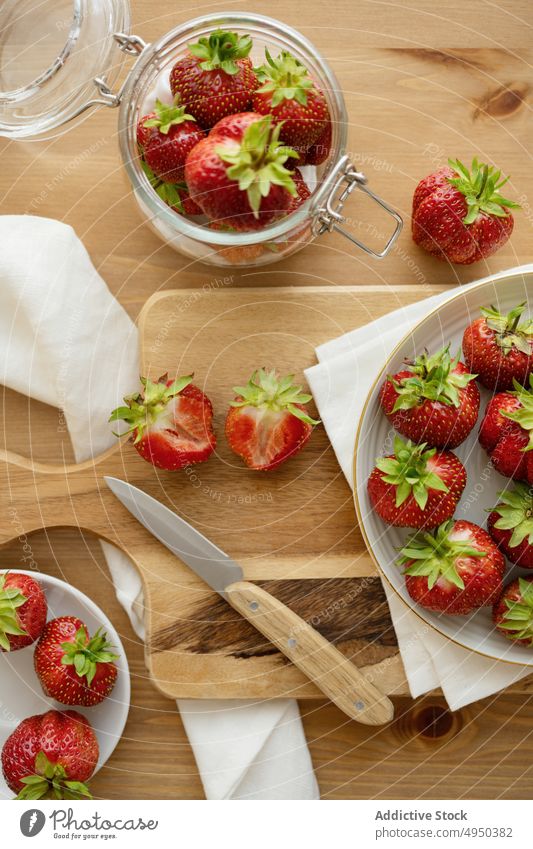 Ripe healthy strawberries served on plates on cutting board strawberry sweet kitchen food vitamin fresh table delicious ingredient jar knife daylight tasty