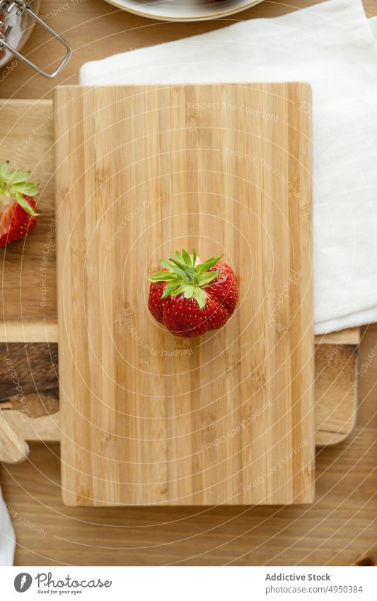 Delicious sweet strawberry placed on wooden board ripe cutting board whole vitamin food fruit fresh healthy ingredient delicious tasty table napkin season yummy