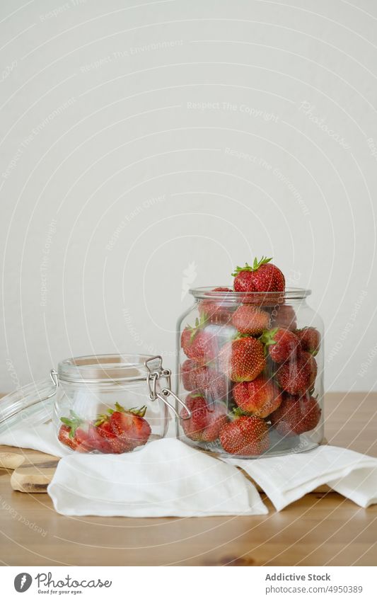 Glass jar with fresh strawberries on wooden table strawberry kitchen food healthy food vitamin cutting board whole ripe delicious ingredient fruit yummy tasty