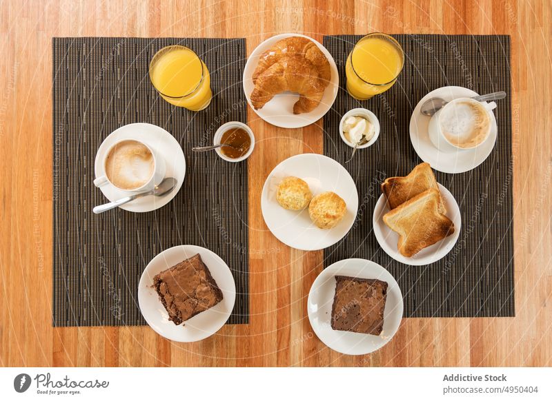 Assorted breakfast food on restaurant table pastry drink composition assorted serve morning beverage yummy tasty delicious croissant syrniki toast brownie latte