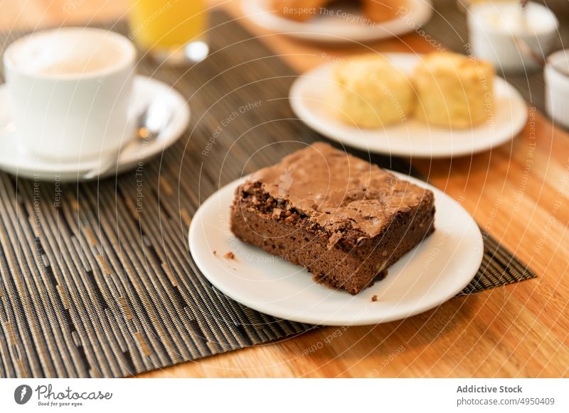 Plate with brownie on cafe table breakfast dessert serve chocolate plate food sweet latte syrniki composition coffee morning fresh gastronomy portion pastry