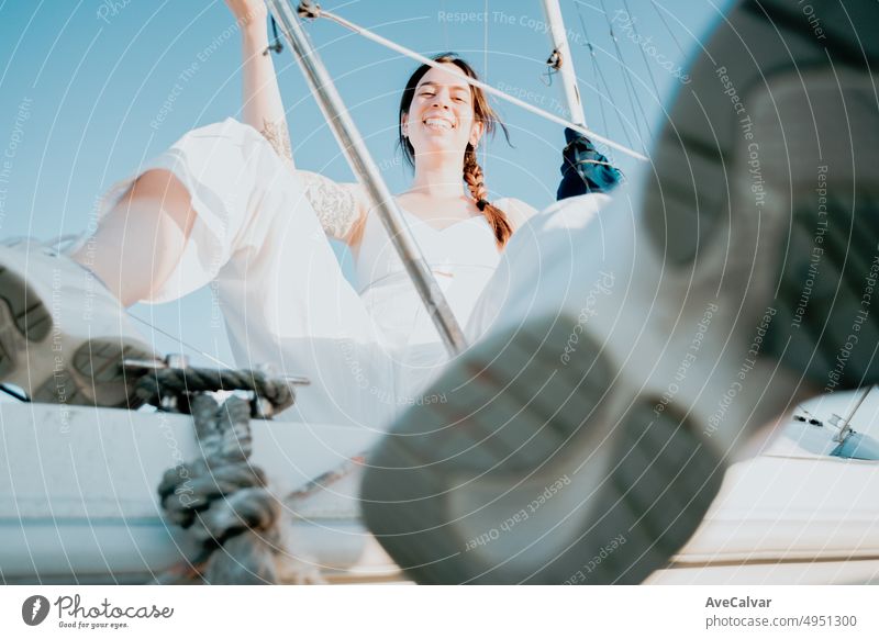 Young woman enjoying summer vacation on a yacht.luxurious yacht cruise, sailing sea travel by luxury boat.Young happy woman on boat having fun. Yachting in Greece,Spain with copy space sunny day
