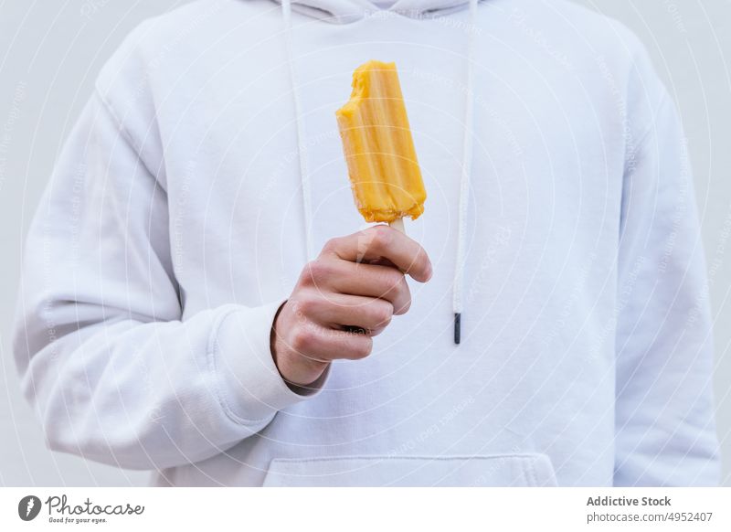 Anonymous man with natural ice lolly looking at camera ice cream cold frozen treat sweet male refresh tasty dessert eco organic yummy guy food delicious