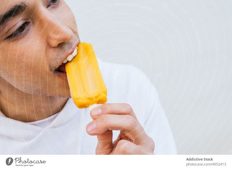 Crop man eating sweet ice lolly ice cream enjoy cold refresh tasty male dessert natural eco organic yummy food treat delicious refreshment nutrition summer