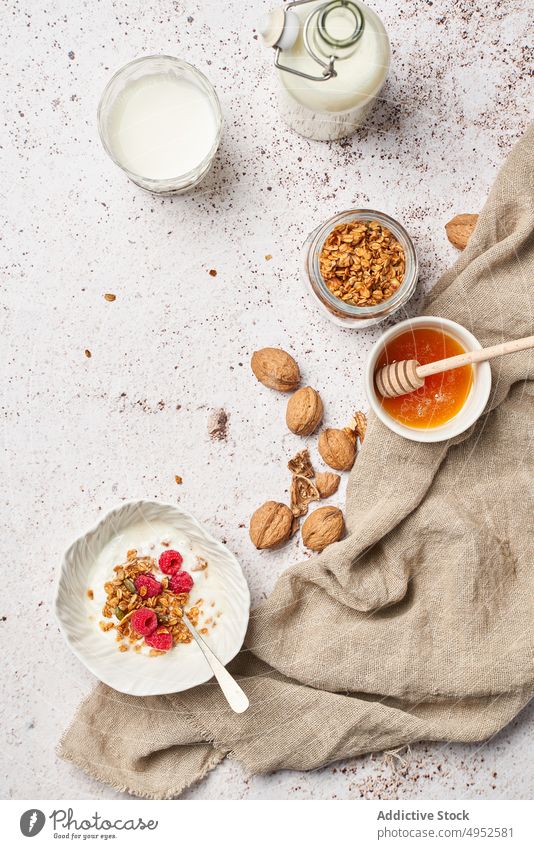 Yummy granola with honey and yogurt table healthy breakfast morning tasty sweet fresh dairy product delicious food dessert meal nutrition snack milk bottle