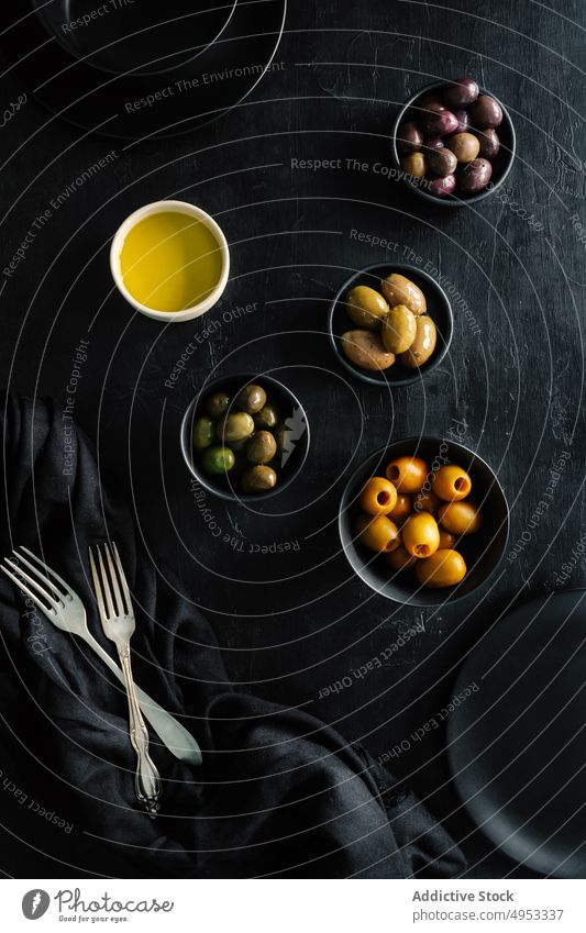 Assortment of olives in elegant black decoration on table variety bowl oil healthy meal gourmet traditional vegetarian lunch dish diet delicious food ripe