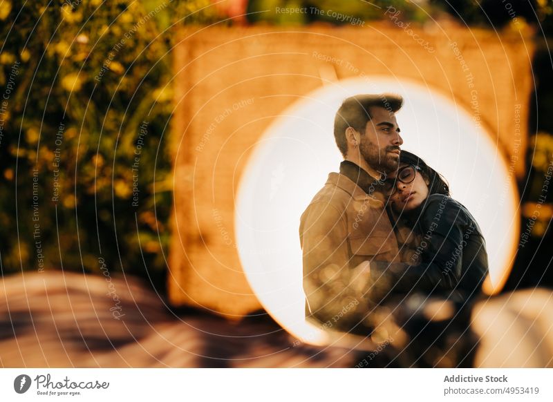 Ethnic couple embracing against mirror in garden embrace relationship love romance spend time enjoy reflection eyes closed dreamy reflective mindfulness