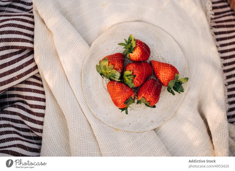 Delicious fresh strawberries on plate on crumpled plaid strawberry healthy food summer vitamin ripe natural sweet delicious organic sepal textile whole bright