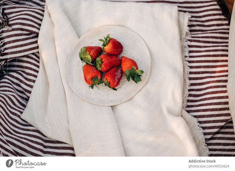 Delicious fresh strawberries on plate on crumpled plaid strawberry healthy food summer vitamin ripe natural sweet delicious organic sepal textile whole bright
