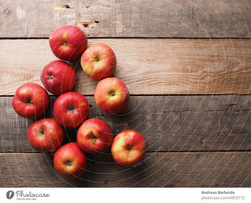 Fresh red organic apples on a wooden table after harvesting, seasonal food apple harvest summertime daytime freshly produce nobody full fall wooden boxes