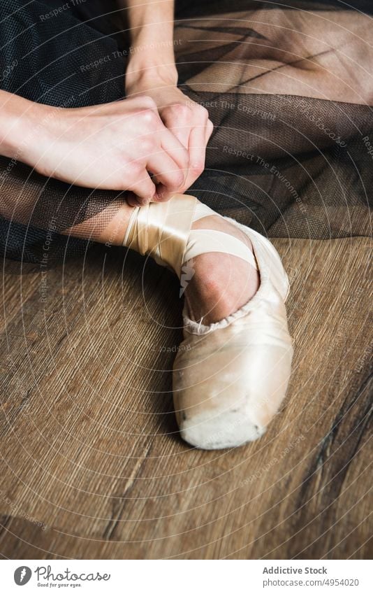 Crop ballerina tying pointe shoes pointes hands wearing person dancer elegance ballet performer sensuality posing artist ribbon putting on contemporary style