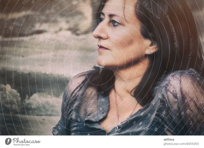 A silent moment. Attractive mature woman in black transparent blouse looks thoughtfully dreaming into the distance. Oh, and hopeful too. Woman portrait Brunette