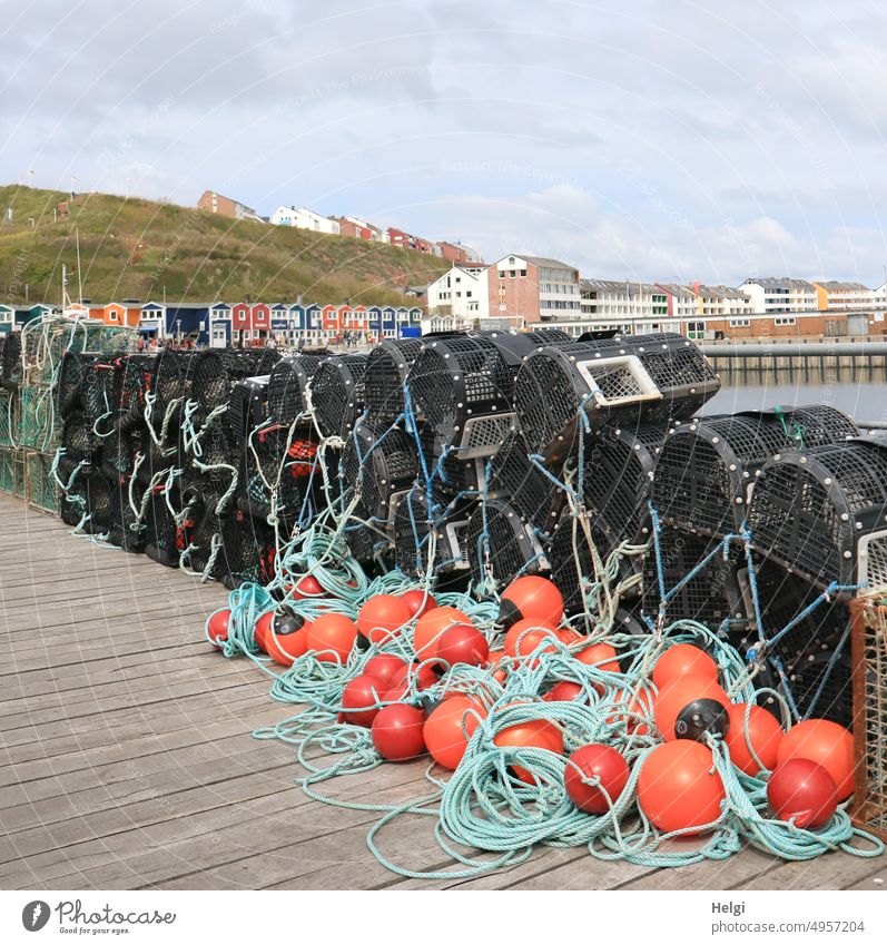 Lobster baskets in the fishing harbor of Helgoland, in the background the lobster stalls and houses in the upper and lower country Lobster Catch Island