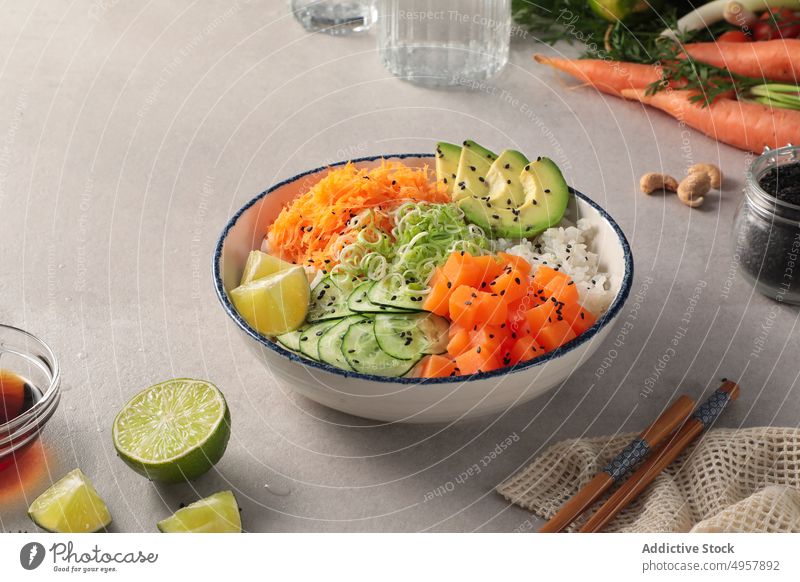 Delicious salmon poke food meal vegetable cuisine dish healthy dinner plate diet lunch bowl delicious above asian avocado chopsticks cucumber dining fish