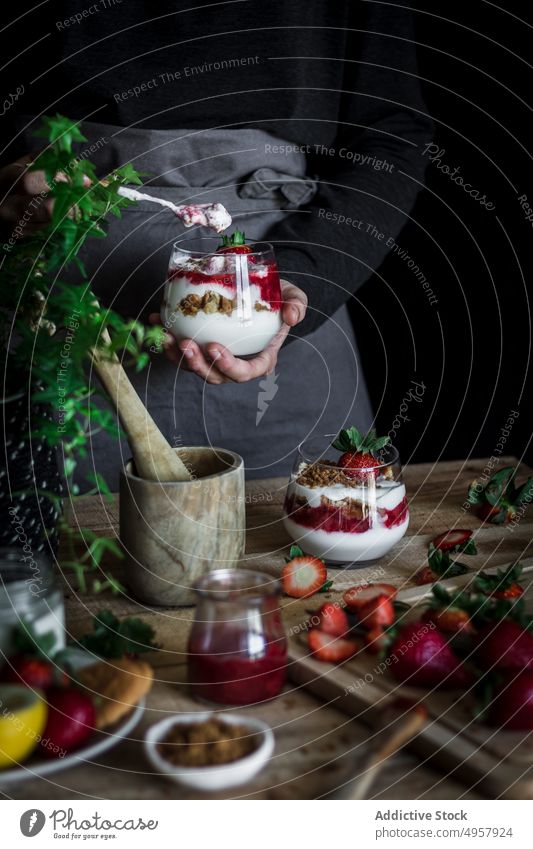 Chef cooking tasty dessert with fresh berries in dark kitchen strawberry cheese food hand cuisine vitamin sweet person healthy slice gastronomy dairy homemade