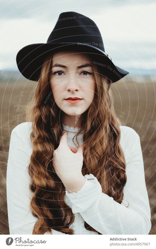 Young hipster woman in the countryside girl nature young person lifestyle hat summer model beauty hair outdoors casual background face stylish retro travel