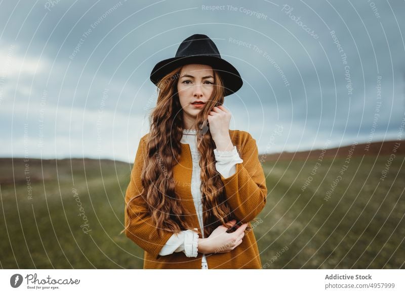 Young hipster woman in the countryside girl nature young person lifestyle hat summer model beauty hair outdoors casual fashion background caucasian natural face